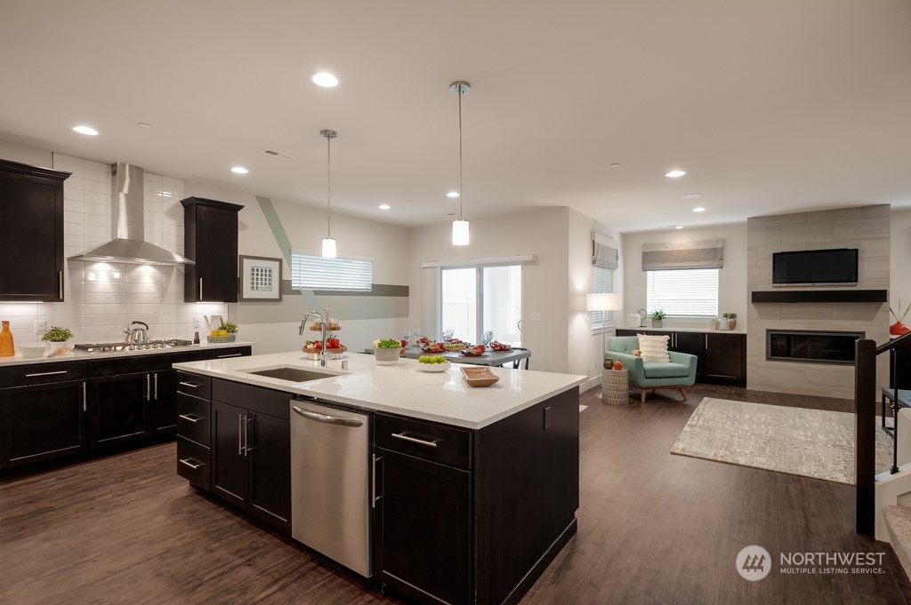 30 177th St S West, Unit IW 81 Bothell, WA 98012 - Photo 11 of 33 a kitchen with a stove a sink a refrigerator and chairs