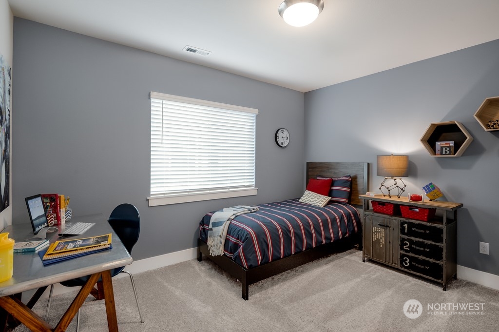 30 177th St S West, Unit IW 81 Bothell, WA 98012 - Photo 25 of 33 a bedroom with a bed and a desk in it