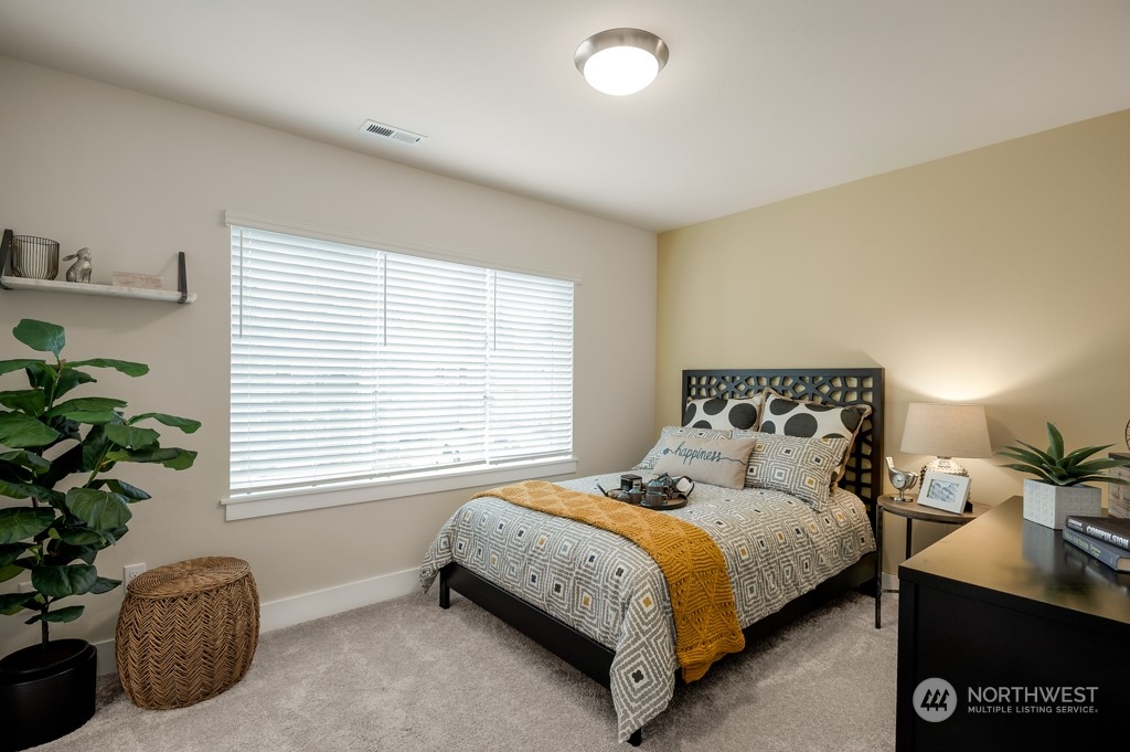 30 177th St S West, Unit IW 81 Bothell, WA 98012 - Photo 26 of 33 a bedroom with bed plant and window