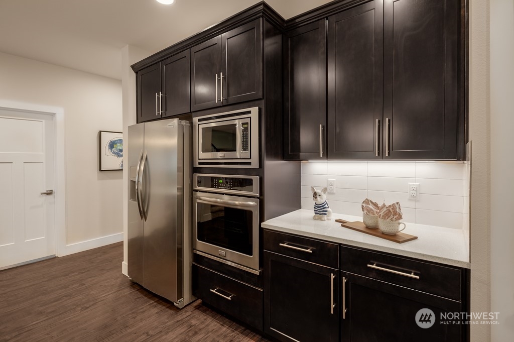 30 177th St S West, Unit IW 81 Bothell, WA 98012 - Photo 7 of 33 a kitchen with granite countertop stainless steel appliances and wooden cabinets
