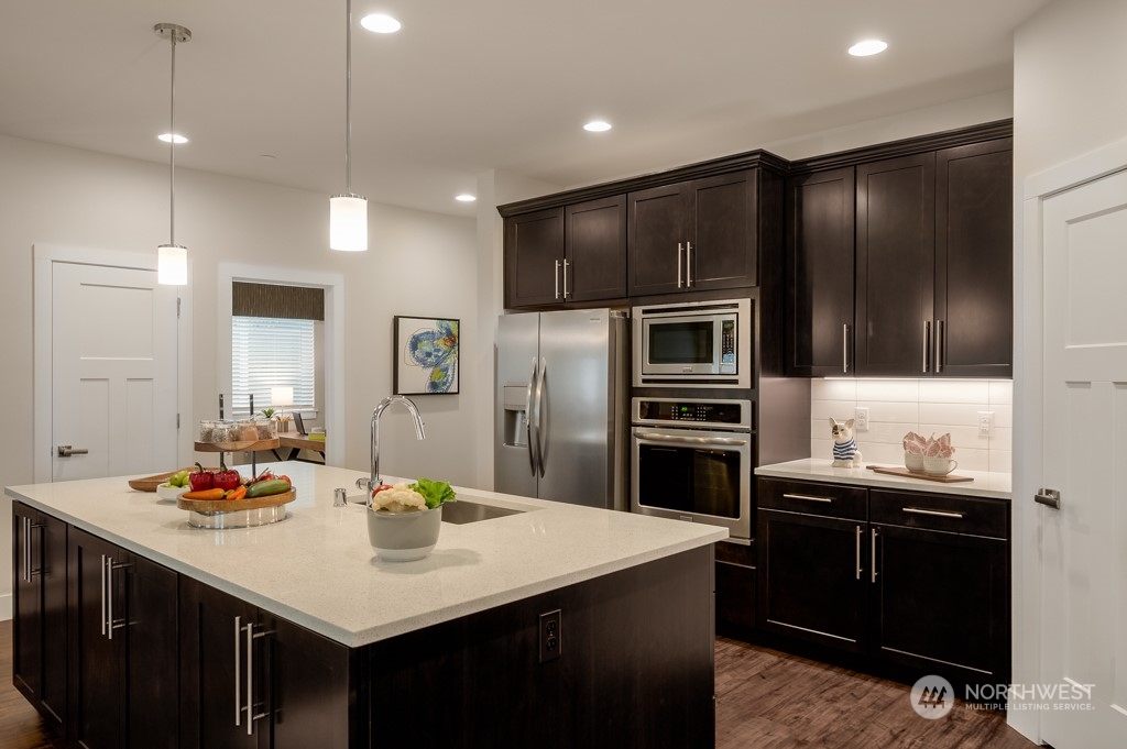 30 177th St S West, Unit IW 81 Bothell, WA 98012 - Photo 9 of 33 a kitchen with stainless steel appliances a sink stove refrigerator and cabinets