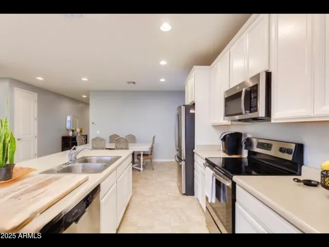 a kitchen that has a sink and a stove top oven