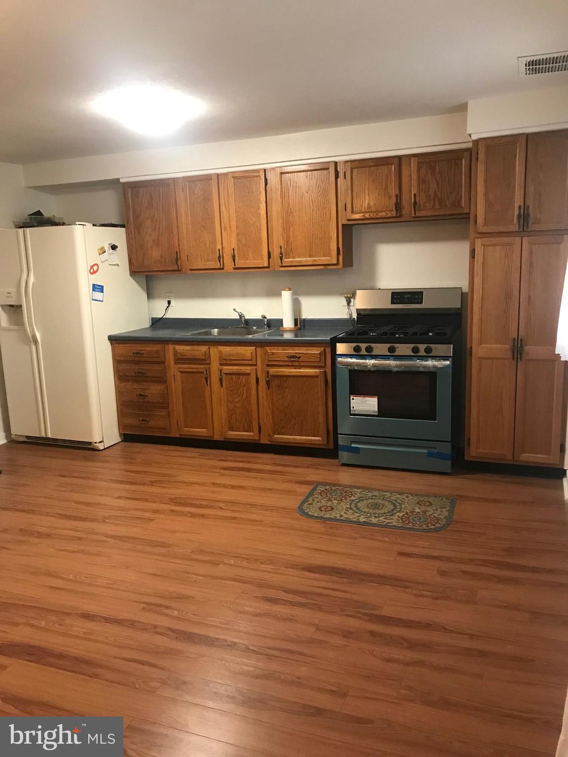 2046 Shore Road Baltimore, MD 21222 - Photo 11 of 11 a kitchen with stainless steel appliances granite countertop a stove a sink and a refrigerator