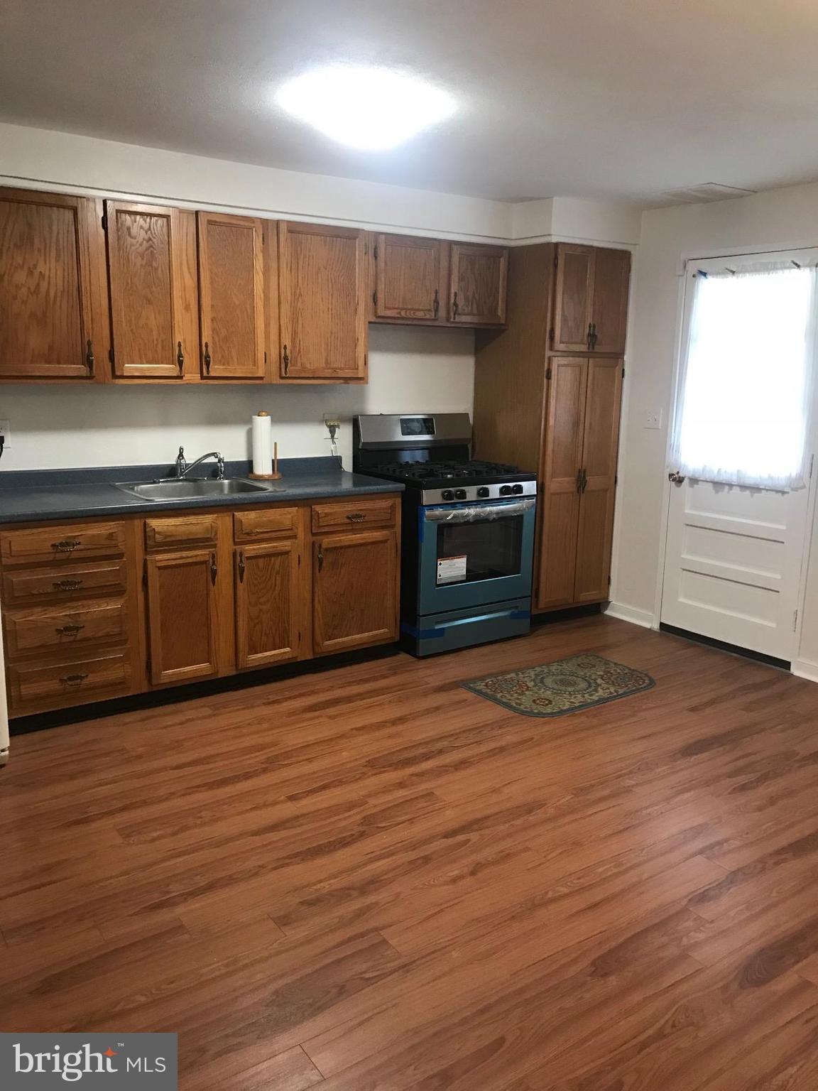 2046 Shore Road Baltimore, MD 21222 - Photo 10 of 11 a kitchen with stainless steel appliances granite countertop a stove a sink and a refrigerator