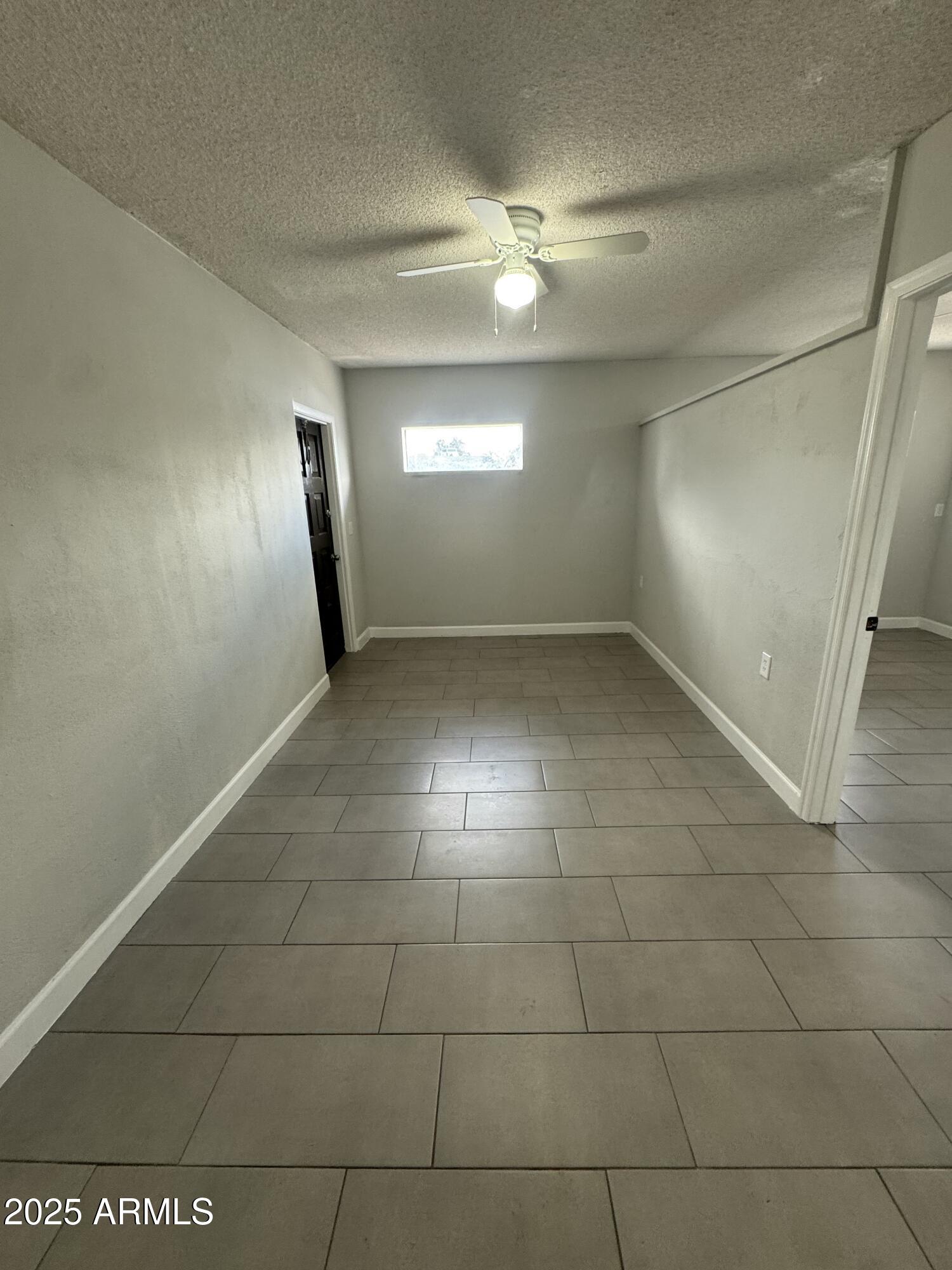 13824 North 33rd Drive, Unit 1 Phoenix, AZ 85053 - Photo 2 of 10 a view of an empty room with a window