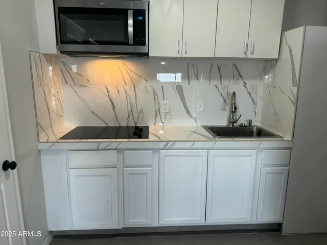 a kitchen with a microwave and sink