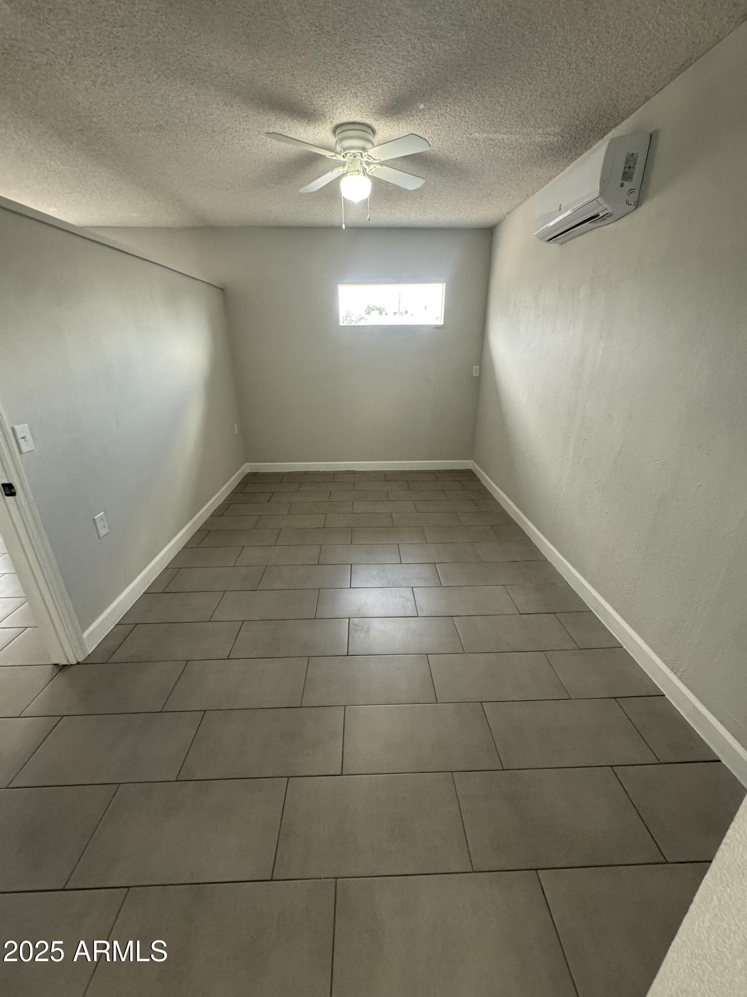 13824 North 33rd Drive, Unit 1 Phoenix, AZ 85053 - Photo 5 of 10 a view of an empty room with a window