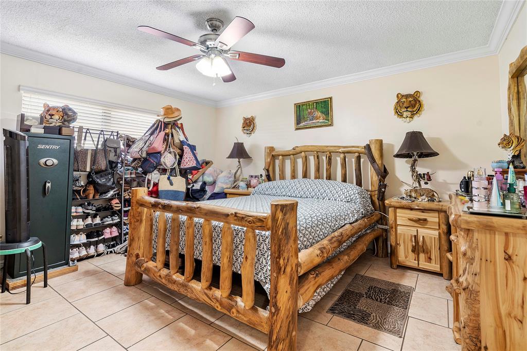 5829 Taylor Street Hollywood, FL 33021 - Photo 15 of 34 a bedroom with bed and a chandelier