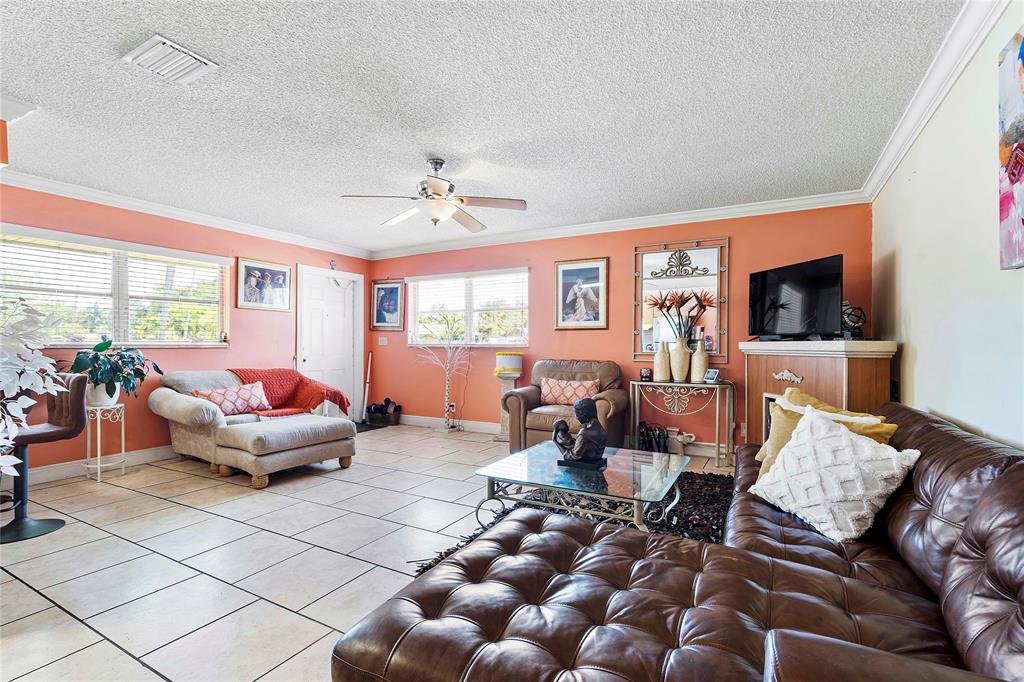 5829 Taylor Street Hollywood, FL 33021 - Photo 23 of 34 a living room with furniture and a flat screen tv