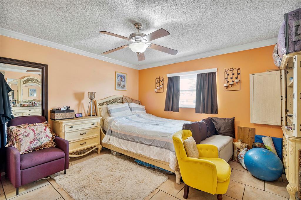 5829 Taylor Street Hollywood, FL 33021 - Photo 30 of 34 a bedroom with a bed and couch