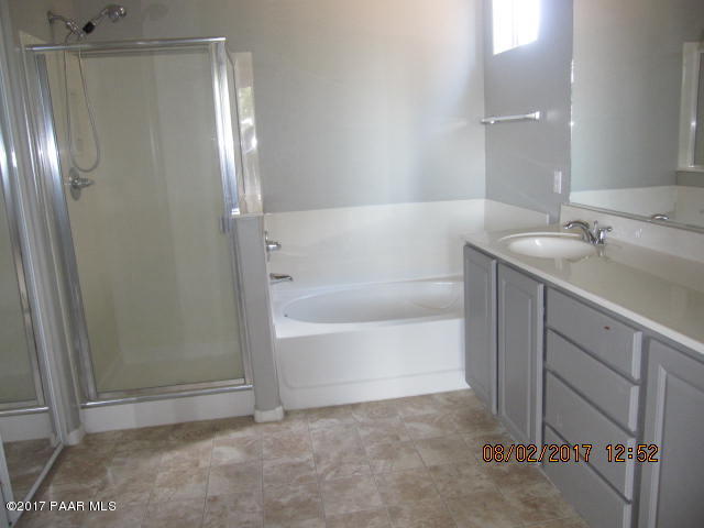 4890 Edgemont Road Prescott Valley, AZ 86314 - Photo 7 of 12 a bathroom with a bathtub and a sink