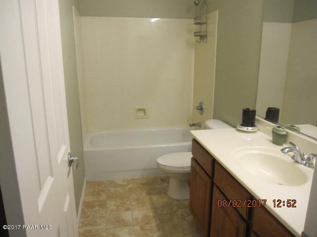4890 Edgemont Road Prescott Valley, AZ 86314 - Photo 8 of 12 a bathroom with a sink a toilet and shower