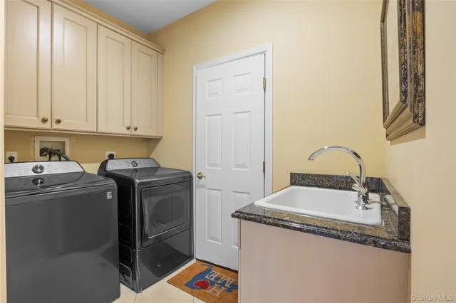 a utility room with sink dryer and washer
