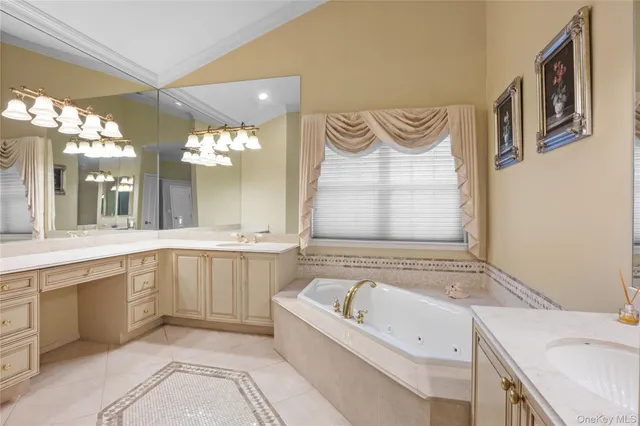a bathroom with a bathtub sink and mirror