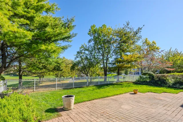 a view of a backyard with large trees