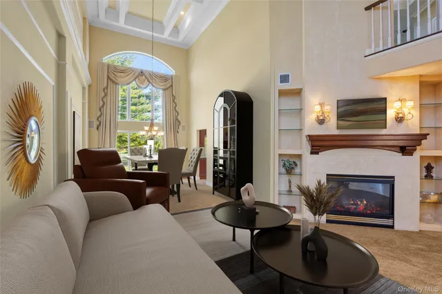 a living room with furniture a fireplace and a large window