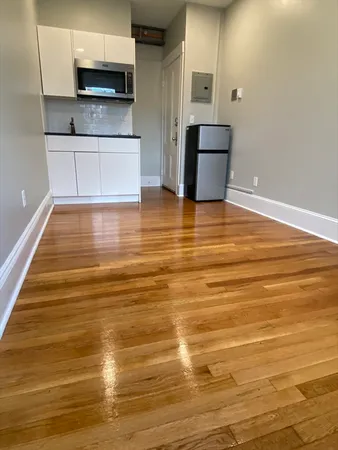 a view of kitchen and kitchen with microwave