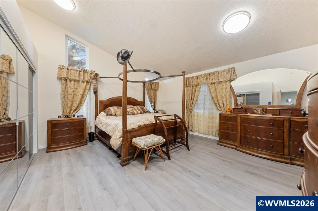 6100 Teal Creek Road Dallas, OR 97338 - Photo 13 of 41 a bedroom with furniture and wooden floor