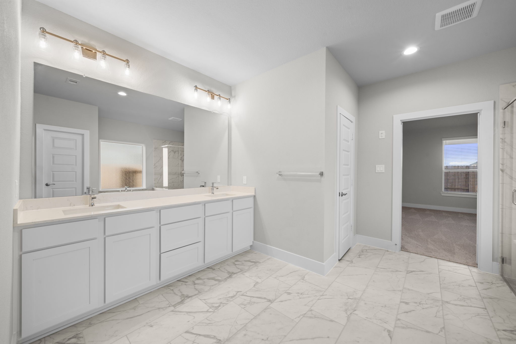 3410 Everglade Lane Rosenberg, TX 77471 - Photo 6 of 16 a spacious bathroom with a mirror vanity and shower