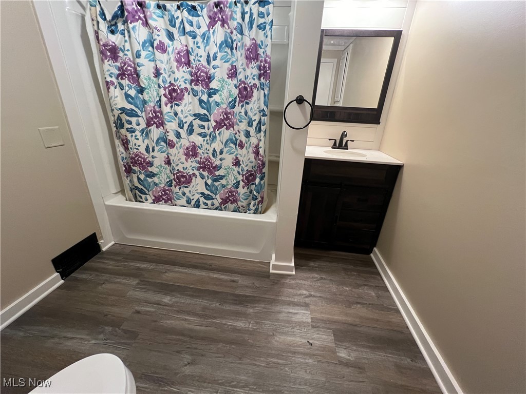 280 Holly Road Northwest Dellroy, OH 44620 - Photo 16 of 26 Full bathroom with shower / bath combo, vanity, toilet, and wood-type flooring
