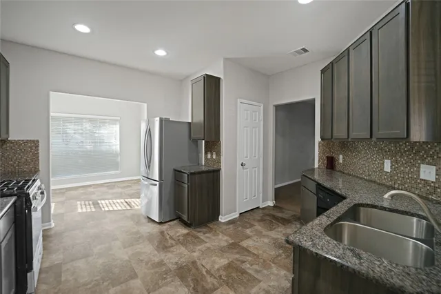 a kitchen with a sink and refrigerator