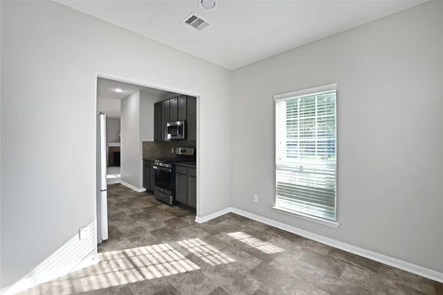 a view of a room window and wooden floor