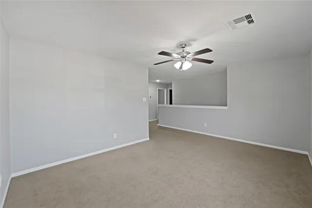 a view of an empty room with a fan