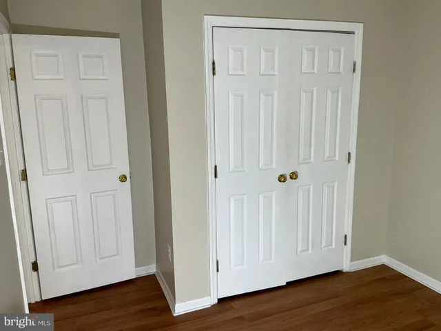 an empty room with wooden floor