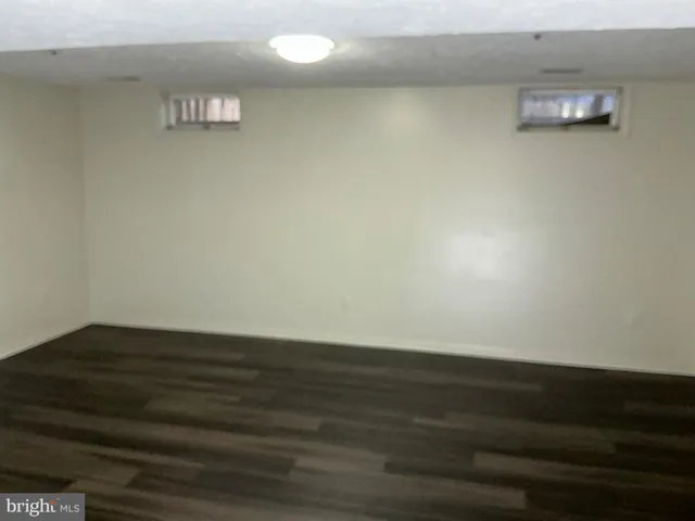 a view of an empty room and wooden floor