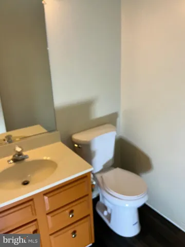 a white toilet sitting next to a bathroom sink