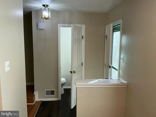 a bathroom with a granite countertop sink a toilet and shower
