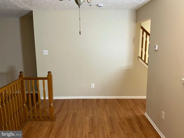 a view of hallway with wooden floor