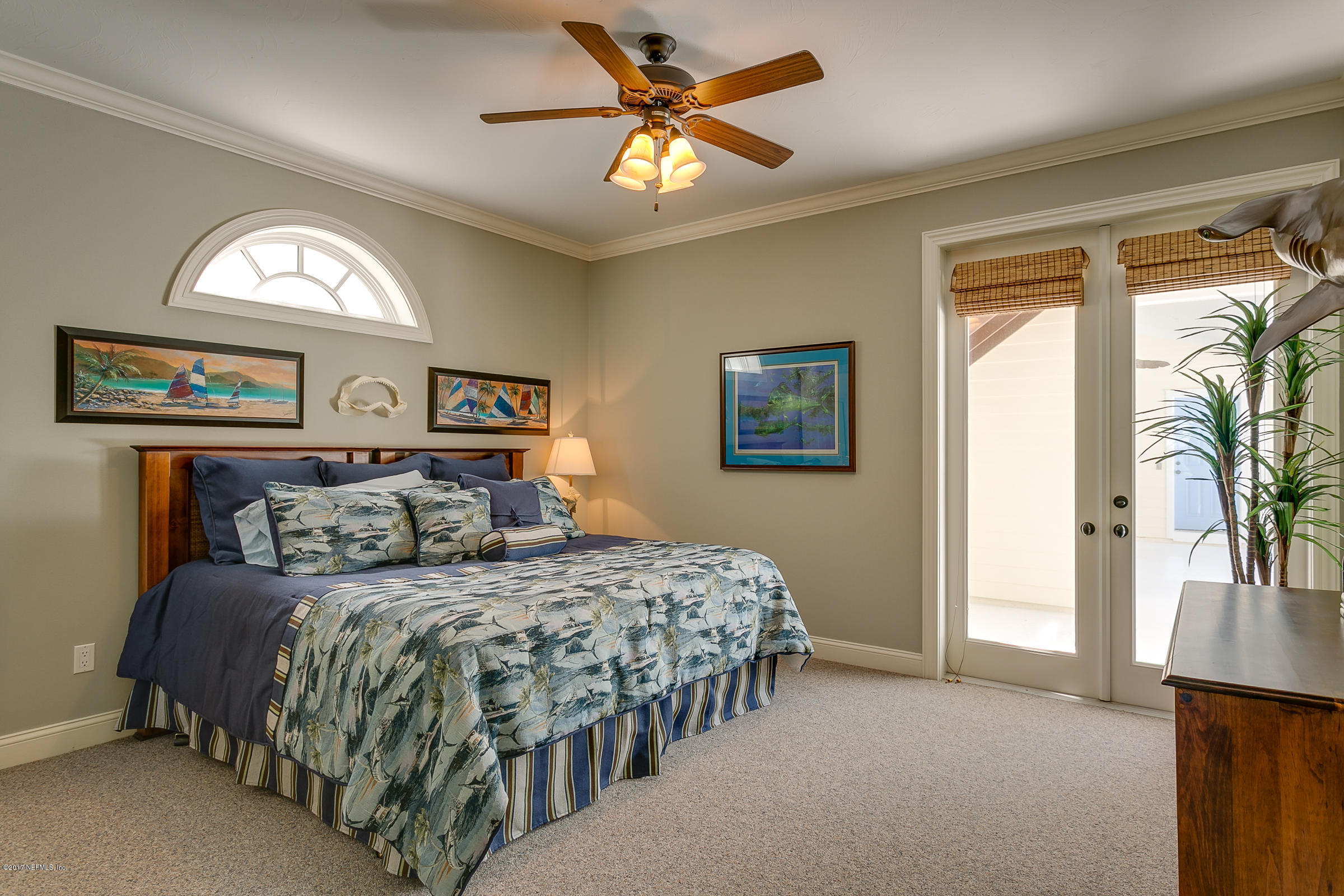 645 Ocean Palm Way St. Augustine, FL 32080 - Photo 11 of 47 a bedroom with a bed and a chandelier
