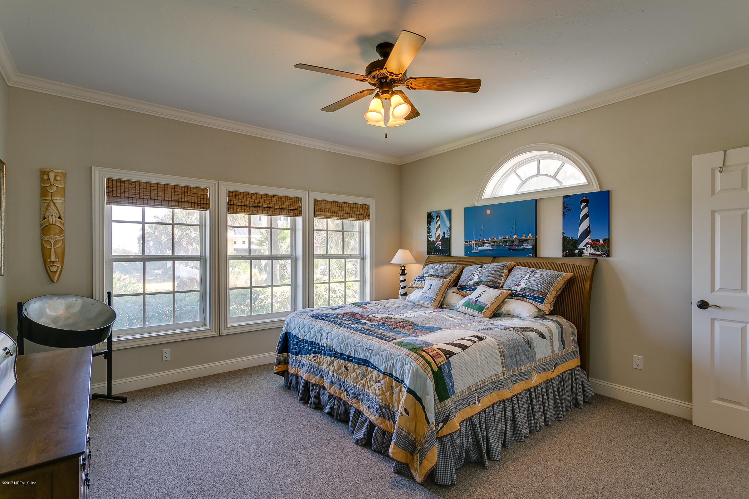 645 Ocean Palm Way St. Augustine, FL 32080 - Photo 13 of 47 a bedroom with a bed and a chandelier