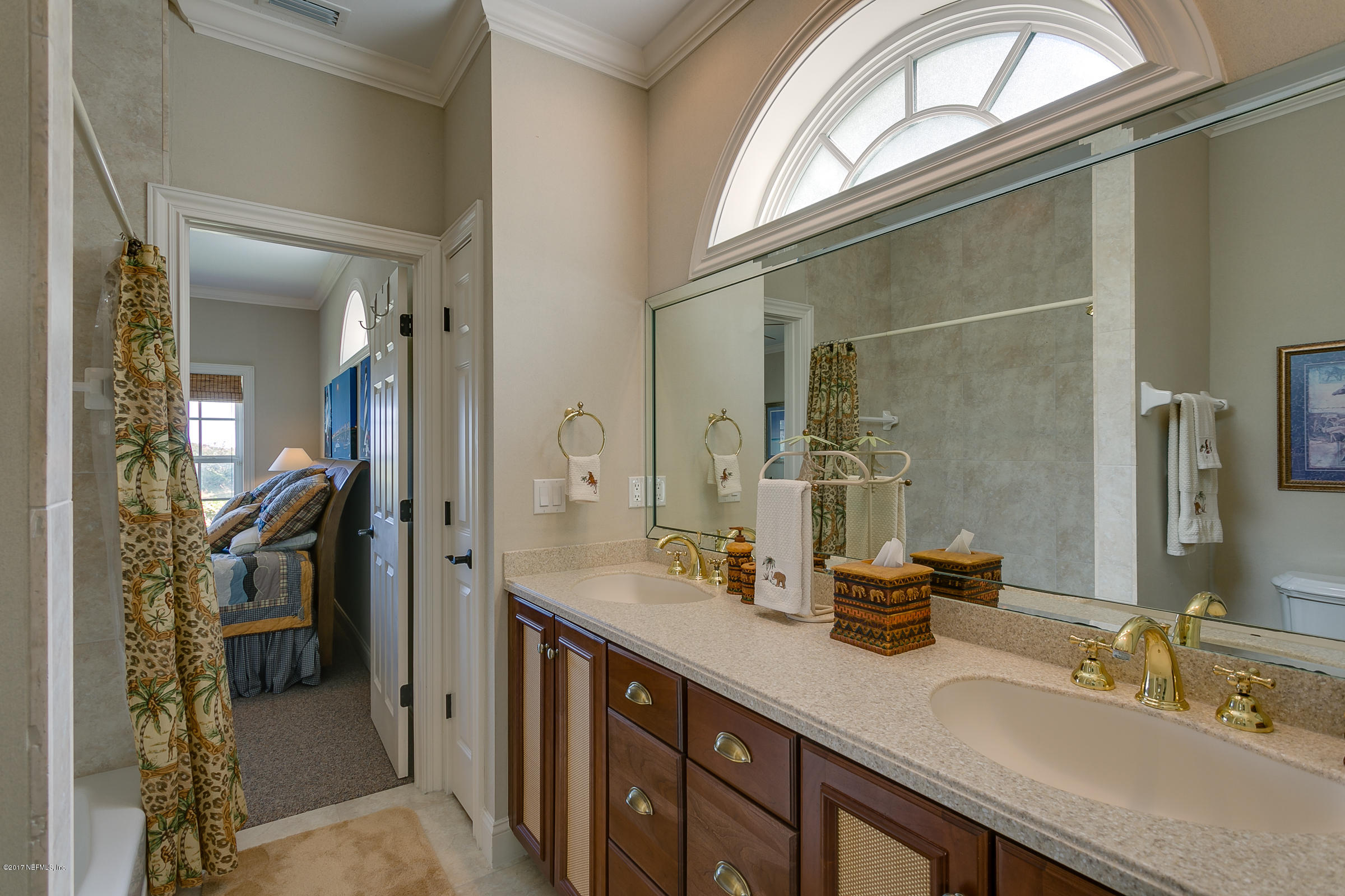 645 Ocean Palm Way St. Augustine, FL 32080 - Photo 18 of 47 a spacious bathroom with a double vanity sink and a mirror