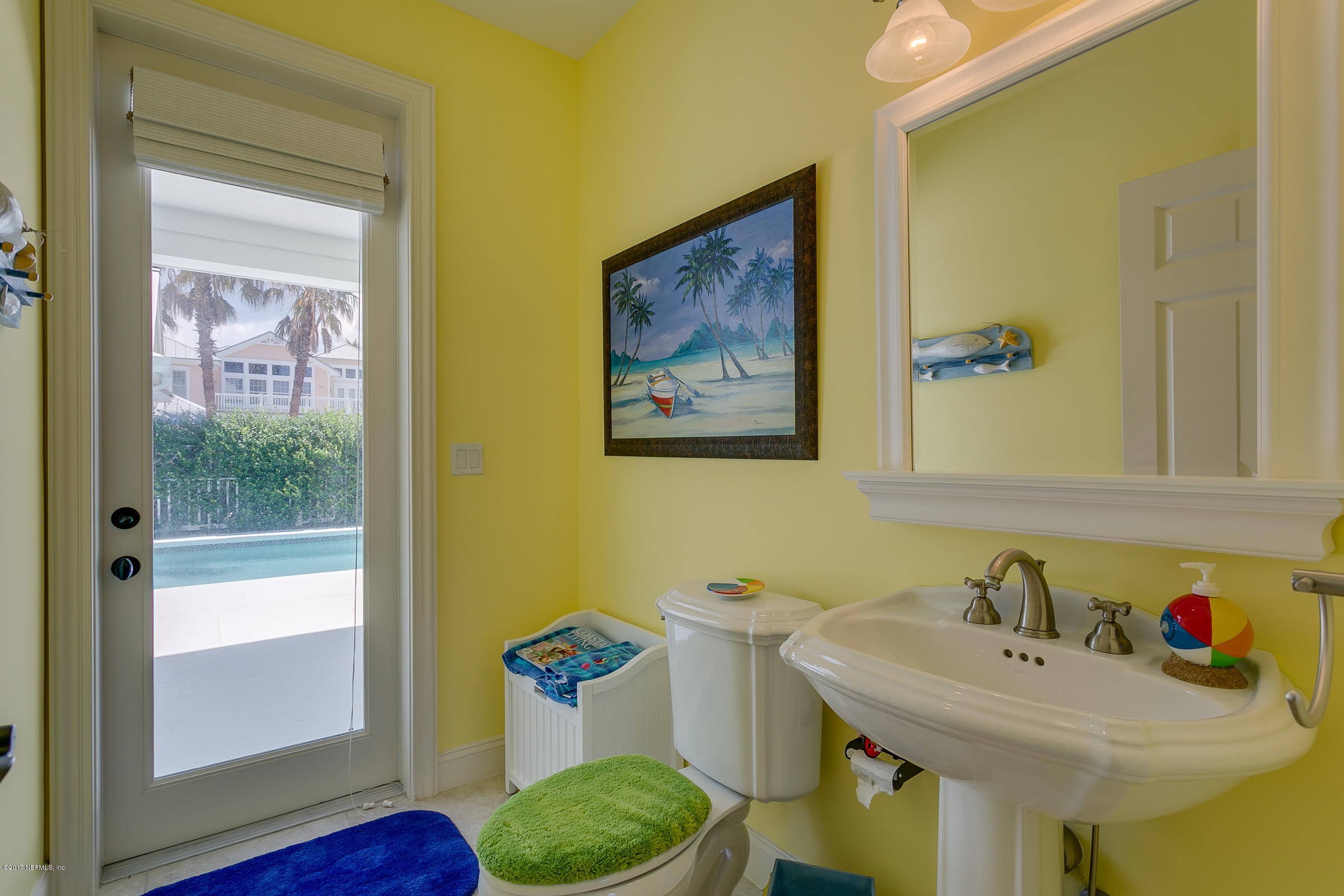 645 Ocean Palm Way St. Augustine, FL 32080 - Photo 22 of 47 a bathroom with a sink and a mirror
