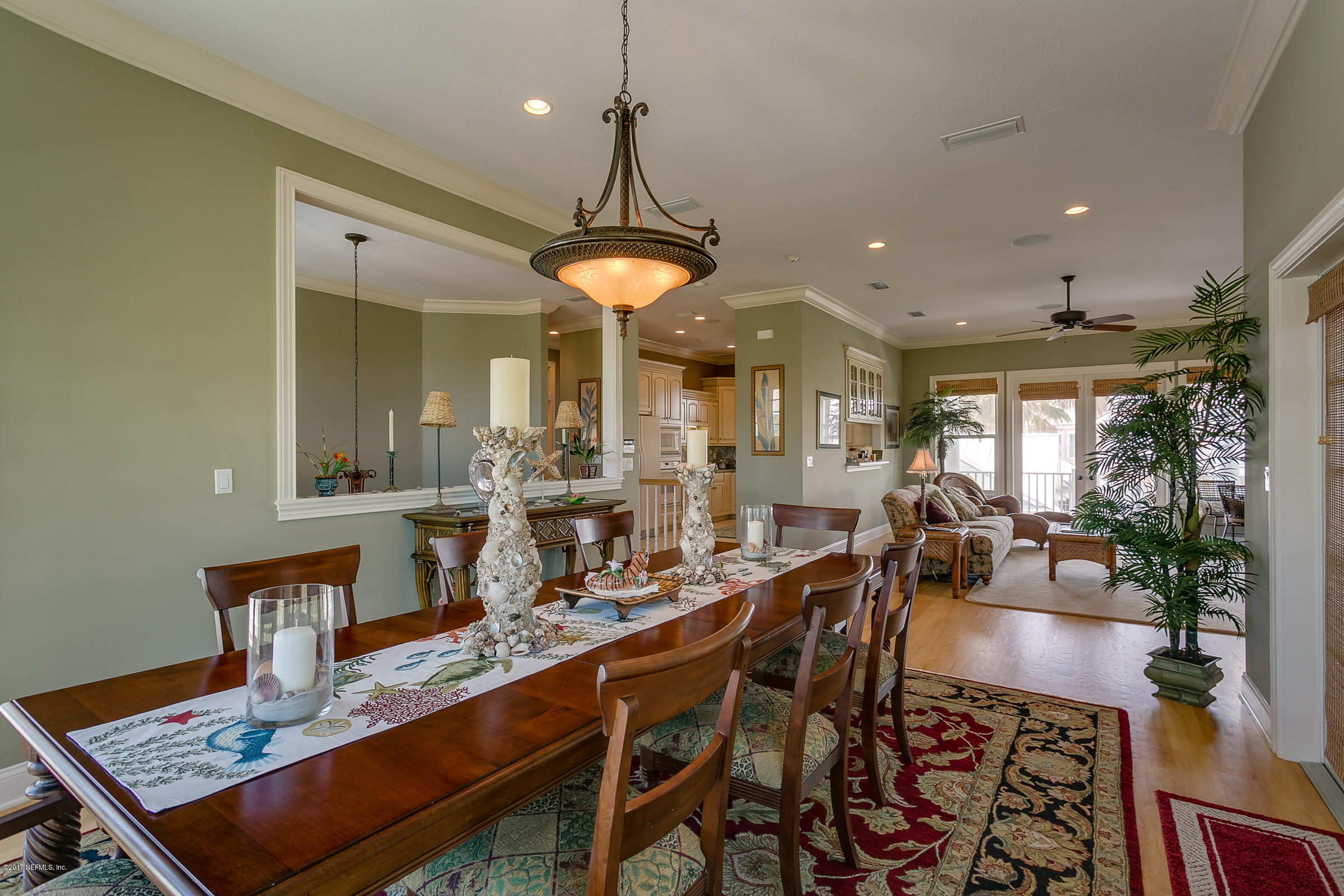 645 Ocean Palm Way St. Augustine, FL 32080 - Photo 28 of 47 a view of a dining room and livingroom with furniture wooden floor a chandelier