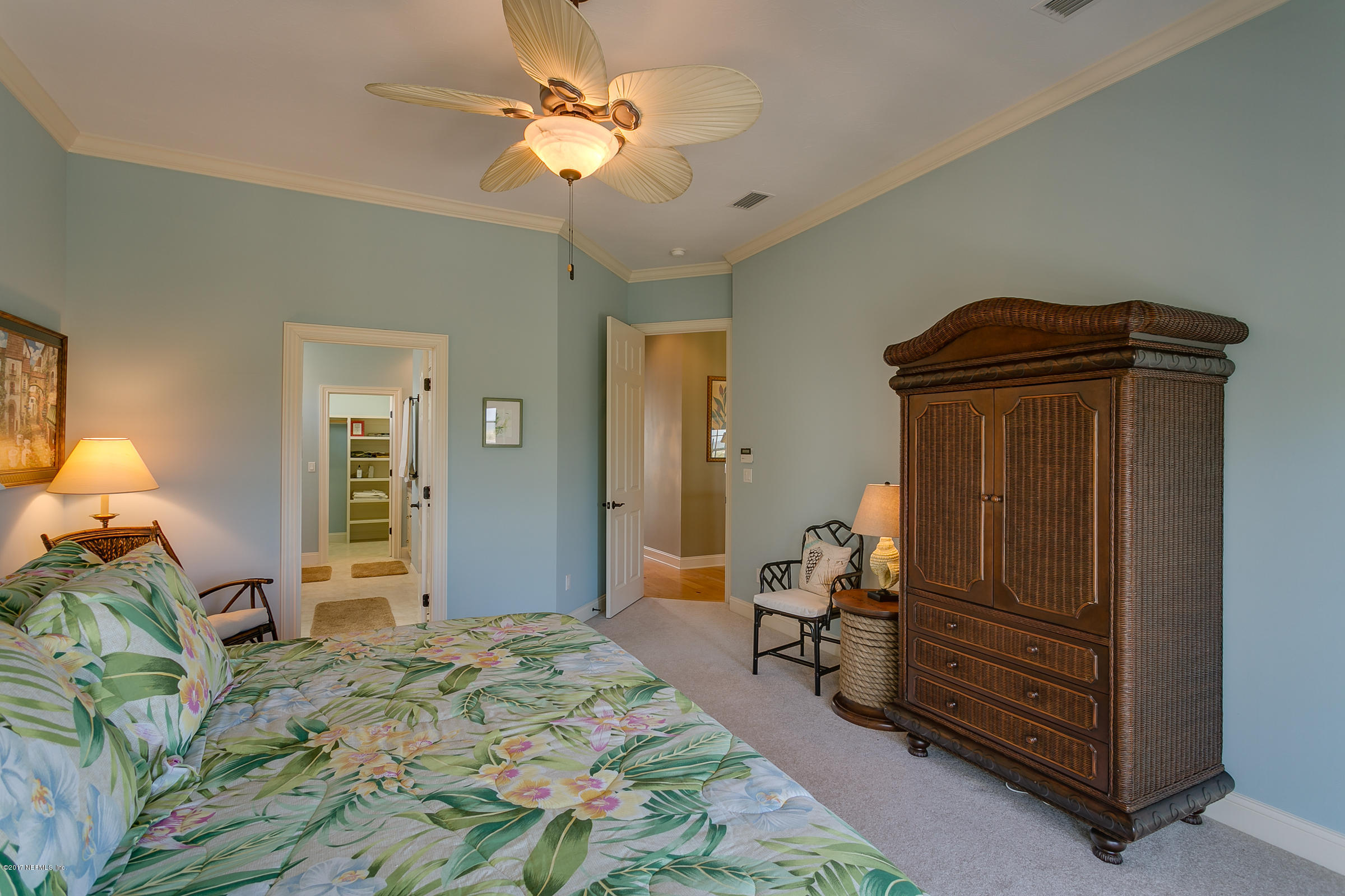645 Ocean Palm Way St. Augustine, FL 32080 - Photo 31 of 47 a bedroom with a bed and a chandelier