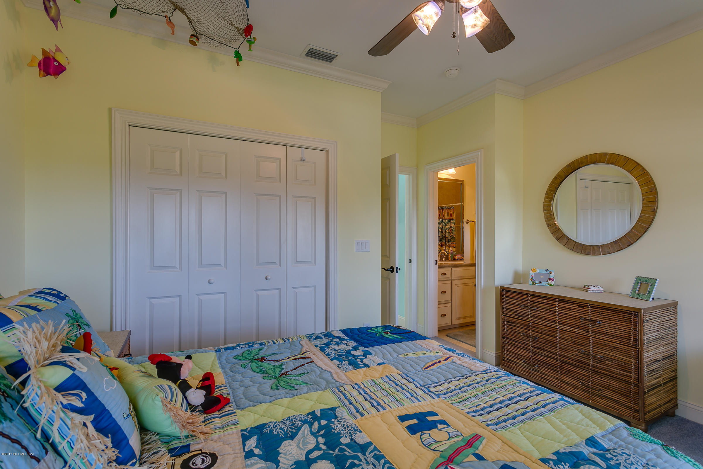 645 Ocean Palm Way St. Augustine, FL 32080 - Photo 10 of 47 a bedroom with a bed and a chandelier
