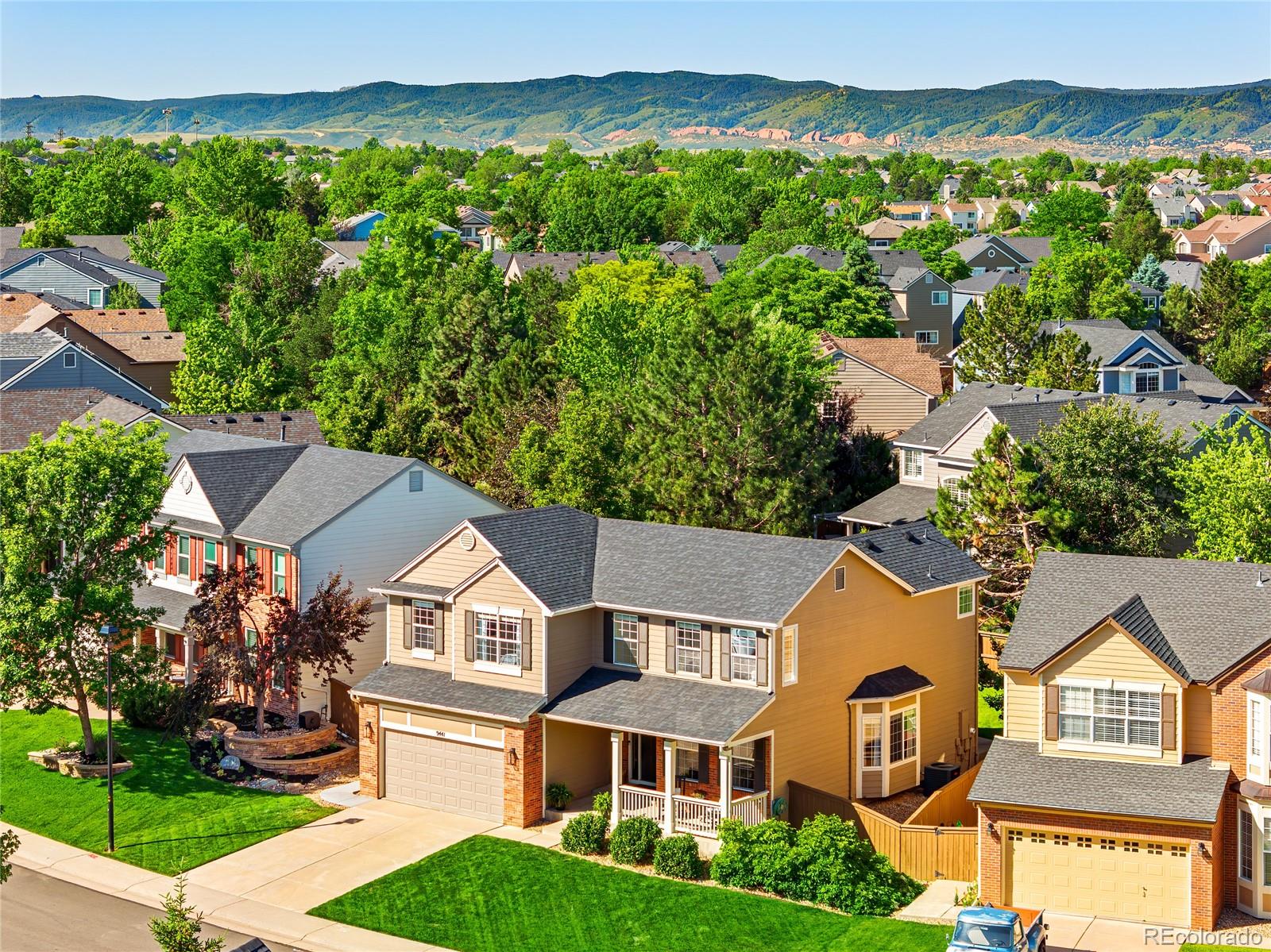 9441 South Hackberry Lane Highlands Ranch, CO 80129 - Photo 2 of 50 an aerial view of residential houses with outdoor space and trees