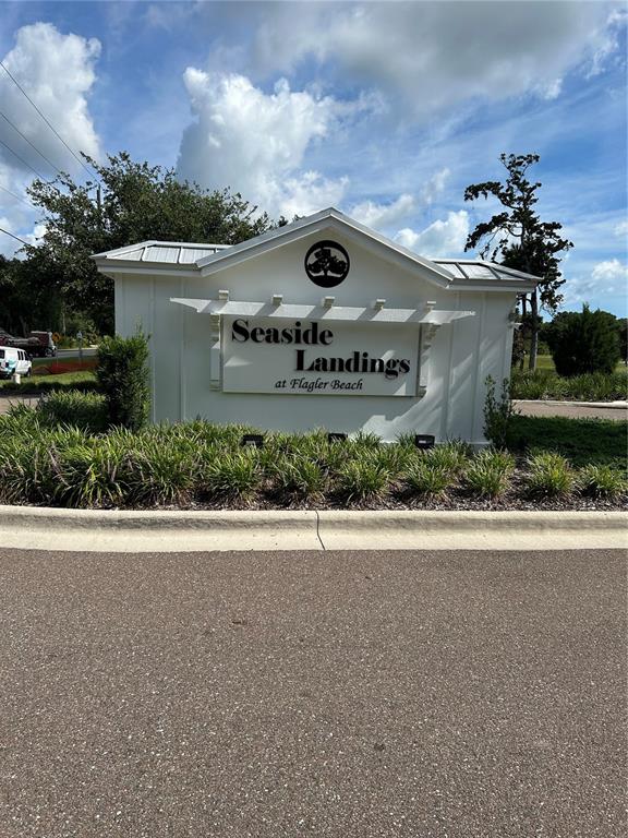 110 Seaside Pt Point Flagler Beach, FL 32136 - Photo 23 of 28 a front view of a house with a yard and garage