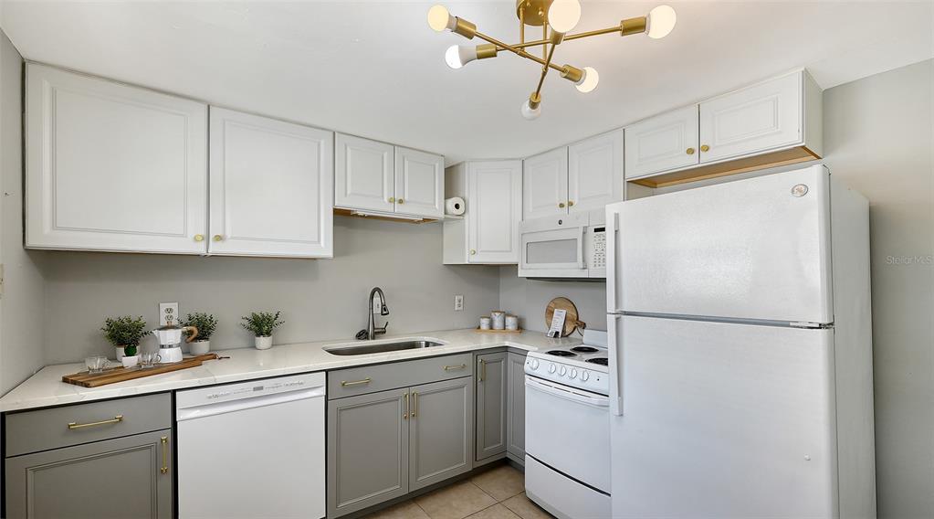 1860 7th Street Sarasota, FL 34236 - Photo 12 of 75 a white refrigerator freezer sitting in a kitchen with white cabinets
