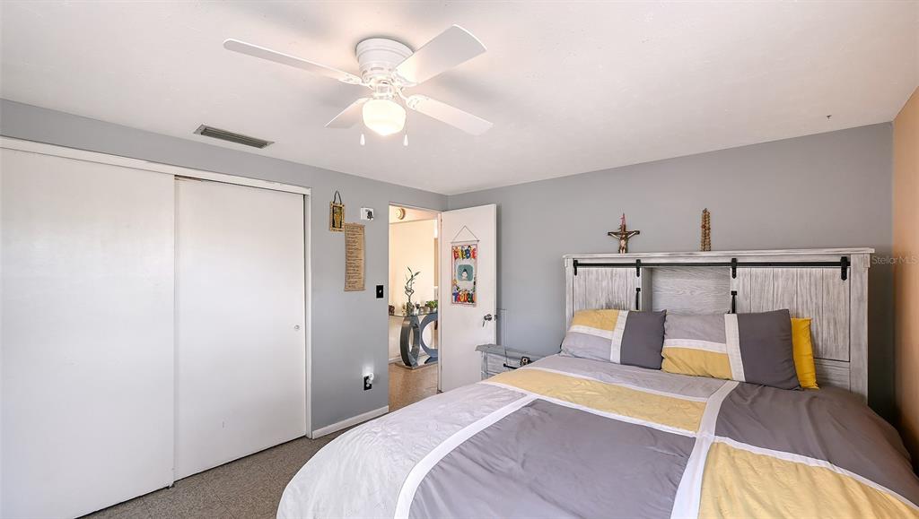 1860 7th Street Sarasota, FL 34236 - Photo 28 of 75 a bedroom with a bed and a chandelier