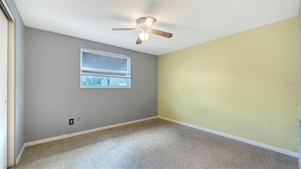 1860 7th Street Sarasota, FL 34236 - Photo 30 of 75 an empty room with a chandelier fan and windows