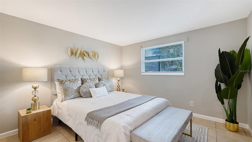 1860 7th Street Sarasota, FL 34236 - Photo 10 of 75 a bedroom with a bed and a potted plant