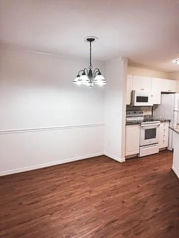 a view of a kitchen with wooden floor and a sink