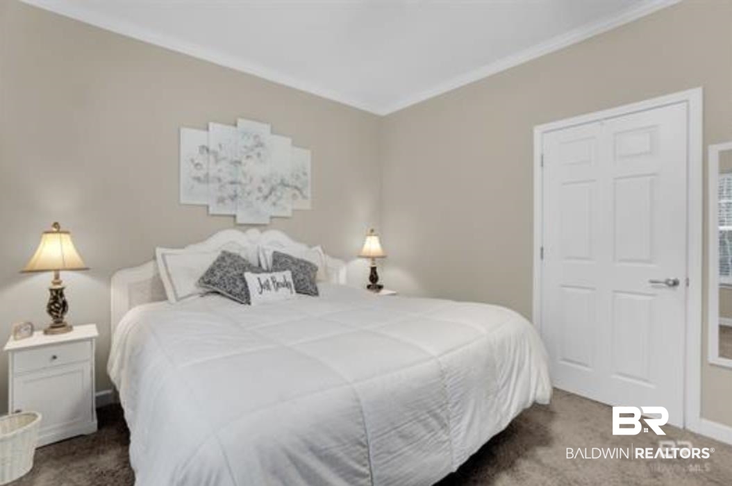 430 West Fort Morgan Road Gulf Shores, AL 36542 - Photo 13 of 27 Carpeted interior room featuring neutral wall paint, white crown molding, and white panel doors