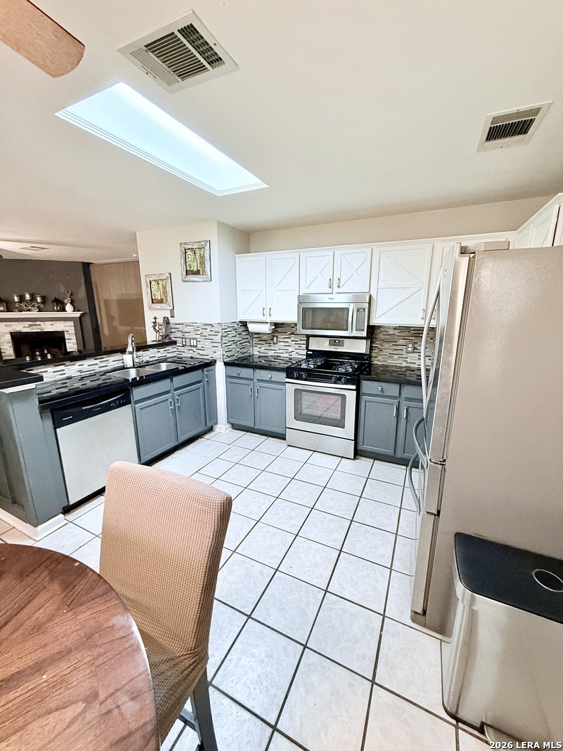 13916 Randalstone Drive Pflugerville, TX 78660 - Photo 11 of 32 a kitchen with stainless steel appliances granite countertop a sink counter space and cabinets