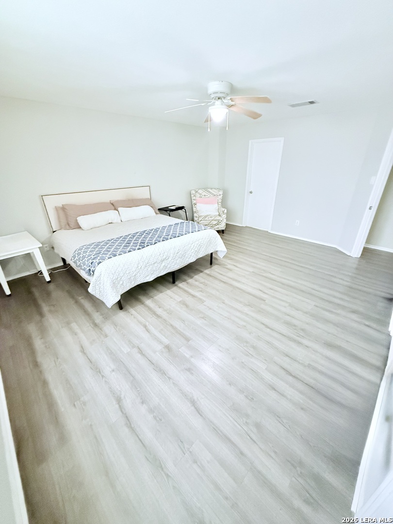 13916 Randalstone Drive Pflugerville, TX 78660 - Photo 15 of 32 a bedroom with a bed and a night stand