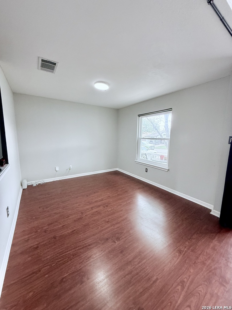 13916 Randalstone Drive Pflugerville, TX 78660 - Photo 6 of 32 an empty room with wooden floor and windows